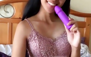 Provocative brunette masturbating with a larger purple dildo
